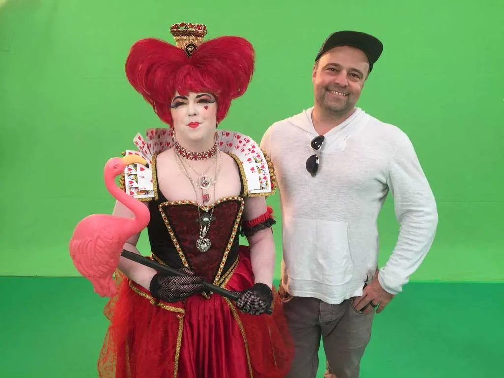 Ryan Trenhaile on a green screen stage with an actor in a Queen of Hearts costume